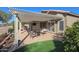 Covered patio with seating area and artificial turf at 19778 N Coyote Lakes Pkwy, Surprise, AZ 85378