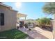 Relaxing backyard patio with seating area, pergola, and built-in grill at 19778 N Coyote Lakes Pkwy, Surprise, AZ 85378