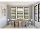 Bright dining room with large windows and modern light fixture at 2060 N Woodburne Pl, Chandler, AZ 85224