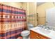 Bathroom with patterned shower curtain, toilet, and vanity at 21295 N 262Nd Dr, Buckeye, AZ 85396