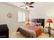 Bedroom with a queen bed, nightstands, and ceiling fan at 21295 N 262Nd Dr, Buckeye, AZ 85396