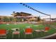 Community area with cornhole and seating at 21295 N 262Nd Dr, Buckeye, AZ 85396