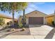 Single-story home with desert landscaping and a two-car garage at 21295 N 262Nd Dr, Buckeye, AZ 85396