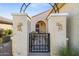 Inviting front entry with decorative gate and unique architectural details at 21295 N 262Nd Dr, Buckeye, AZ 85396