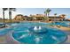 Resort-style pool and spa with a large clubhouse in the background at 21295 N 262Nd Dr, Buckeye, AZ 85396