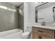 Modern bathroom with gray tile, updated vanity, and bathtub at 2193 S Tucana Ln, Gilbert, AZ 85295