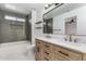 Bathroom with double vanity, gray tile shower, and modern fixtures at 2193 S Tucana Ln, Gilbert, AZ 85295