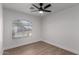 Bright bedroom with ceiling fan and arched window at 2193 S Tucana Ln, Gilbert, AZ 85295