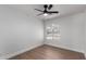 Bedroom with wood-look floors, ceiling fan, and arched window at 2193 S Tucana Ln, Gilbert, AZ 85295