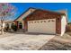 Front view of a home with a brick facade and a two-car garage at 2193 S Tucana Ln, Gilbert, AZ 85295