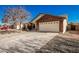 House exterior featuring a two-car garage and a large driveway at 2193 S Tucana Ln, Gilbert, AZ 85295