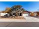 Attractive brick home with a two-car garage and mature trees at 2193 S Tucana Ln, Gilbert, AZ 85295