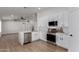 Modern kitchen featuring white cabinets, stainless steel appliances, and a marble-look island at 2193 S Tucana Ln, Gilbert, AZ 85295