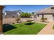 Relaxing backyard with hammock, artificial turf, and a paved pathway at 21987 E Stacey Rd, Queen Creek, AZ 85142