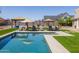 Large rectangular pool surrounded by artificial turf and lounge chairs at 21987 E Stacey Rd, Queen Creek, AZ 85142