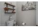 Small bathroom with floating shelves, toilet, and decorative accents at 21987 E Stacey Rd, Queen Creek, AZ 85142