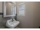 Small bathroom with pedestal sink, mirror, and tiled walls at 21987 E Stacey Rd, Queen Creek, AZ 85142