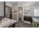 Elegant bathroom with dark vanity, marble countertops, and a large soaking tub at 21987 E Stacey Rd, Queen Creek, AZ 85142