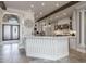 Modern kitchen with white cabinets, marble countertops, and a large island at 21987 E Stacey Rd, Queen Creek, AZ 85142