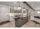 Bright kitchen features white cabinets, marble countertops, and a large kitchen island at 21987 E Stacey Rd, Queen Creek, AZ 85142