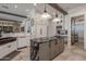 Modern kitchen with a large island, white cabinets, and black marble countertops at 21987 E Stacey Rd, Queen Creek, AZ 85142