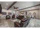 Spacious living area with exposed beams, a fireplace, and an open floor plan at 21987 E Stacey Rd, Queen Creek, AZ 85142