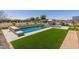 Relaxing pool area with artificial turf and plenty of space for lounging at 21987 E Stacey Rd, Queen Creek, AZ 85142