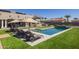 Inviting pool area with multiple lounge chairs and umbrellas for relaxation at 21987 E Stacey Rd, Queen Creek, AZ 85142