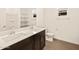 Double vanity sinks, sleek fixtures, and tile floors enhance this modern bathroom space at 22541 W Pontiac Dr, Surprise, AZ 85387