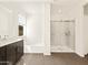 Well-lit bathroom with vanity, soaking tub, and glass shower enclosure at 22541 W Pontiac Dr, Surprise, AZ 85387
