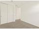 Bright bedroom featuring a large closet with double doors and neutral-toned carpet at 22541 W Pontiac Dr, Surprise, AZ 85387