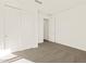 Bedroom featuring double closets, plush carpeting, and a modern interior door at 22541 W Pontiac Dr, Surprise, AZ 85387