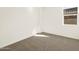 Comfortable bedroom with neutral carpet, white walls, and a window at 22541 W Pontiac Dr, Surprise, AZ 85387