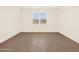 Bedroom with a window providing plenty of natural light and wood-look tile flooring at 22541 W Pontiac Dr, Surprise, AZ 85387