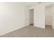 Bedroom features neutral carpet, white walls, door and open doorway at 22541 W Pontiac Dr, Surprise, AZ 85387