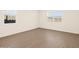 Bedroom with tile floors and bright natural light from two windows at 22541 W Pontiac Dr, Surprise, AZ 85387