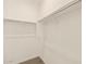 This is a well-lit closet with white walls, a metal rod for hanging clothes, and neutral-colored carpet at 22541 W Pontiac Dr, Surprise, AZ 85387
