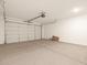 Spacious garage with a standard garage door and concrete flooring at 22541 W Pontiac Dr, Surprise, AZ 85387