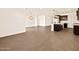 Spacious living room with wood-look tile floors leading to the kitchen with a center island at 22541 W Pontiac Dr, Surprise, AZ 85387