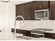 A stunning gourmet kitchen features stainless steel appliances and a designer backsplash at 22541 W Pontiac Dr, Surprise, AZ 85387