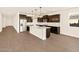 Bright kitchen featuring stainless steel appliances, granite countertops, and a center island at 22541 W Pontiac Dr, Surprise, AZ 85387