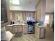 Galley-style kitchen features light cabinets, stainless steel appliances, and breakfast nook seating at 2271 S Seminole Dr, Apache Junction, AZ 85119