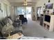 Bright living room with plush carpeting, ceiling fan, and a sliding glass door to outdoor space at 2271 S Seminole Dr, Apache Junction, AZ 85119