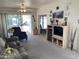 Bright living room with plush carpeting, ceiling fan, and a sliding glass door to outdoor space at 2271 S Seminole Dr, Apache Junction, AZ 85119