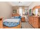 Cozy bedroom with wooden furniture and blue bedding at 22917 E Camina Buena Vis, Queen Creek, AZ 85142