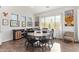 Charming dining area with round table and six black chairs at 22917 E Camina Buena Vis, Queen Creek, AZ 85142