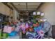 Overstuffed garage with various items at 22917 E Camina Buena Vis, Queen Creek, AZ 85142