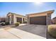 Two-car garage with brown doors and stone exterior at 22917 E Camina Buena Vis, Queen Creek, AZ 85142