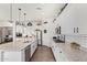 Modern kitchen with white cabinets, granite counters and island at 22917 E Camina Buena Vis, Queen Creek, AZ 85142