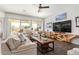 Bright living room with comfy seating, large TV, and stylish coffee table at 22917 E Camina Buena Vis, Queen Creek, AZ 85142